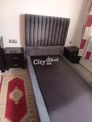 Un lit avec matelat et tables de chevet